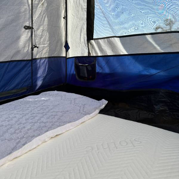 Slothie portable sleep solution set up on a bed